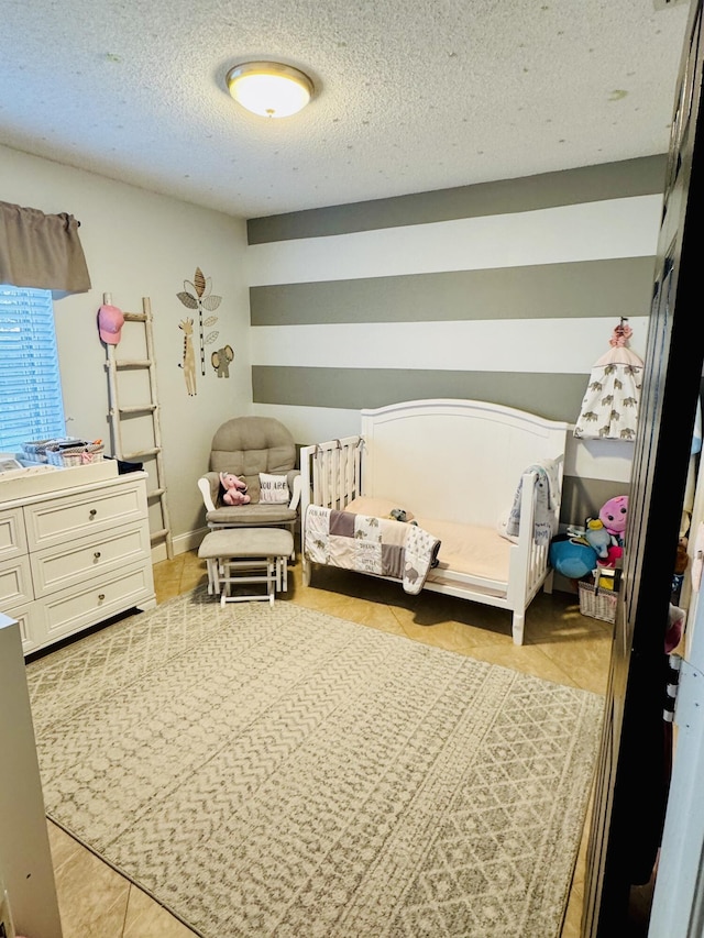 tiled bedroom with a textured ceiling