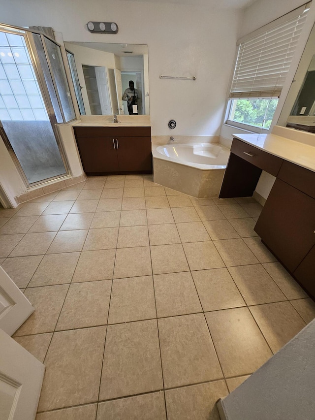 bathroom with tile patterned floors, vanity, and plus walk in shower