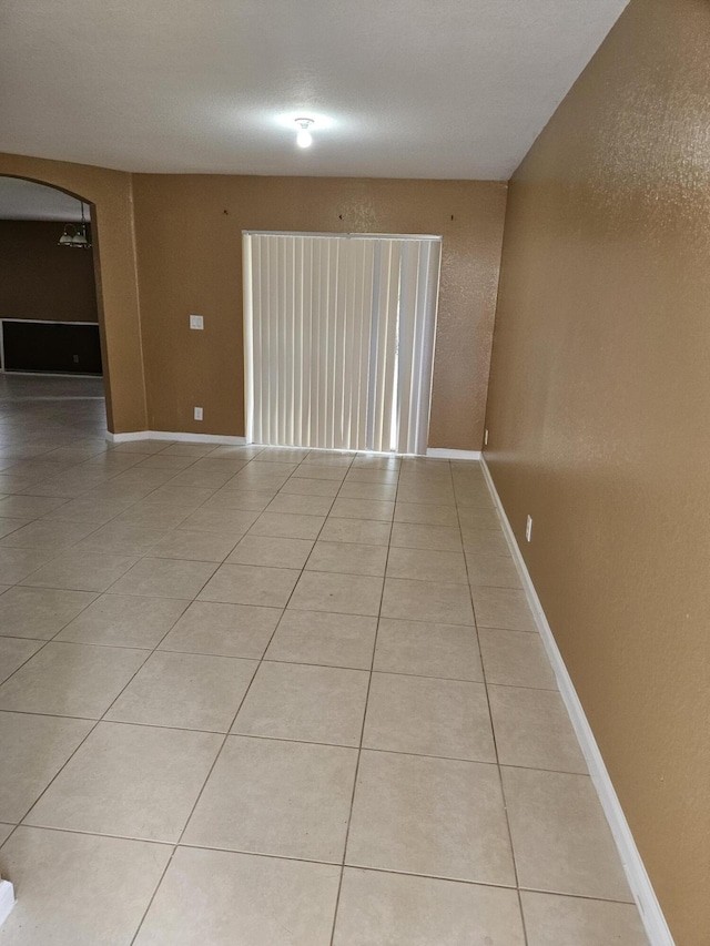 tiled empty room with ceiling fan