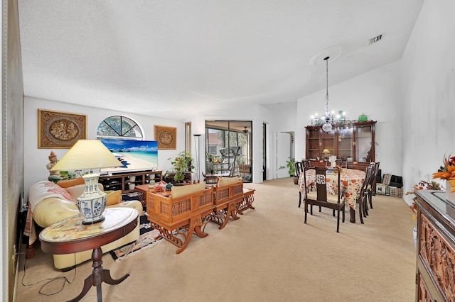 living room with light carpet and an inviting chandelier