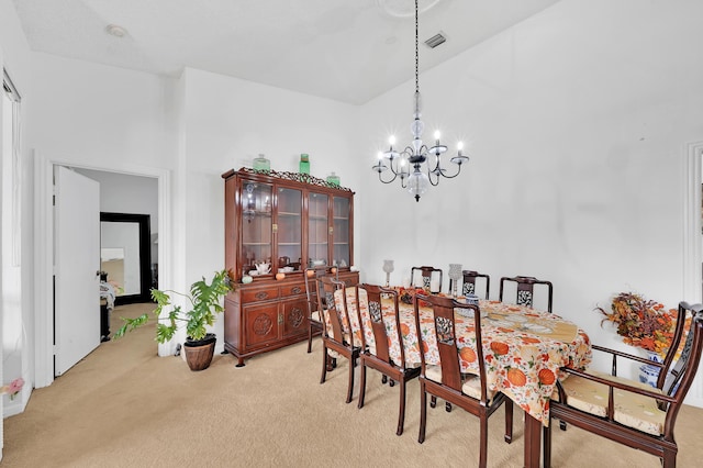 dining room with light carpet and an inviting chandelier