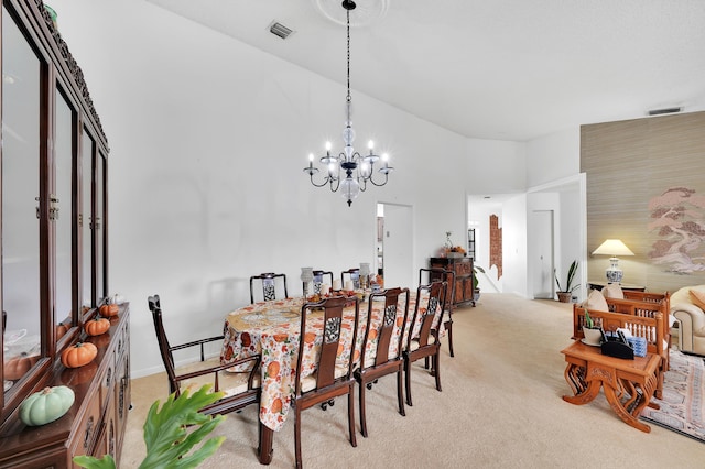 carpeted dining space featuring a towering ceiling and a chandelier