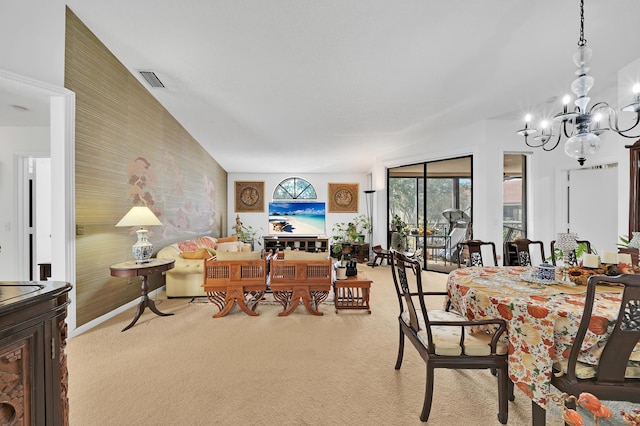 dining space featuring a chandelier, light carpet, and lofted ceiling