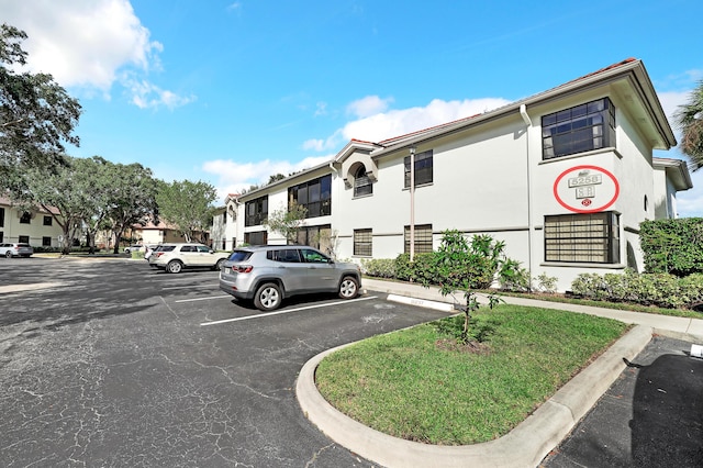 5258 Europa Dr Unit H, Boynton Beach, FL 33437 - view of property with uncovered parking and a residential view