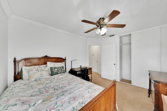 carpeted bedroom with ceiling fan, crown molding, and a textured ceiling