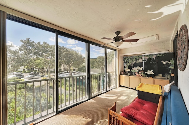 sunroom / solarium featuring ceiling fan