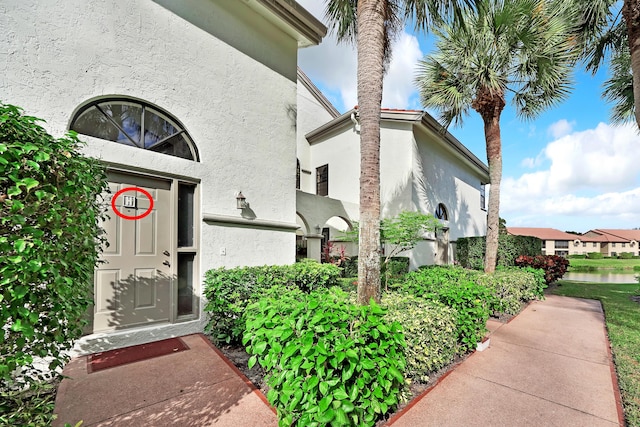 5258 Europa Dr Unit H, Boynton Beach, FL 33437 - doorway to property with stucco siding