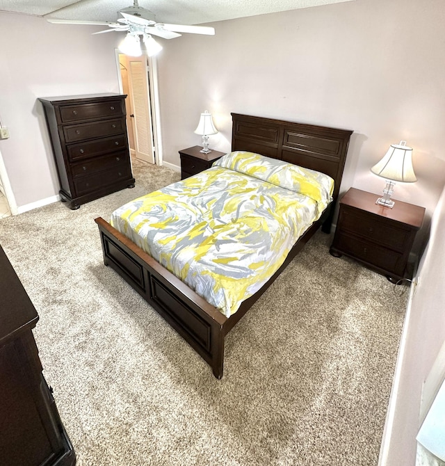 carpeted bedroom with a textured ceiling and ceiling fan