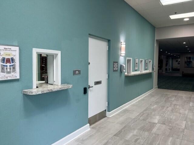 hallway featuring a high ceiling and a paneled ceiling