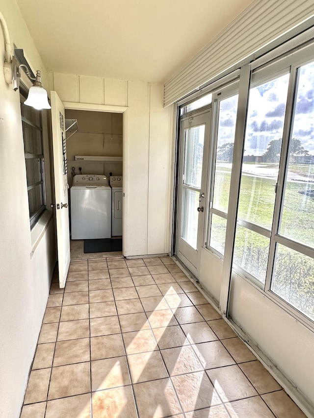 interior space with washer and clothes dryer and light tile patterned flooring