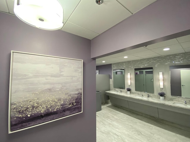 bathroom with a paneled ceiling, vanity, and toilet