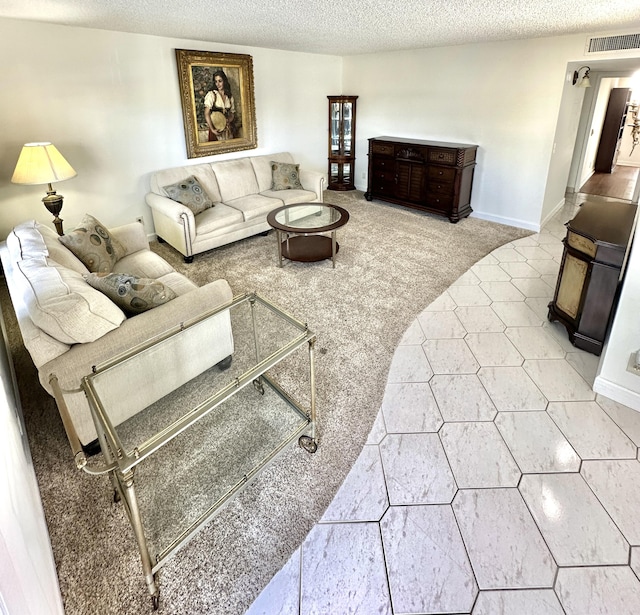 living room with a textured ceiling and light carpet