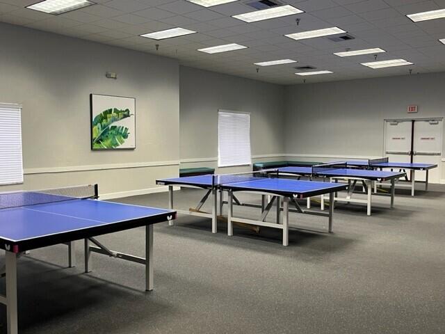 recreation room with a drop ceiling and carpet floors