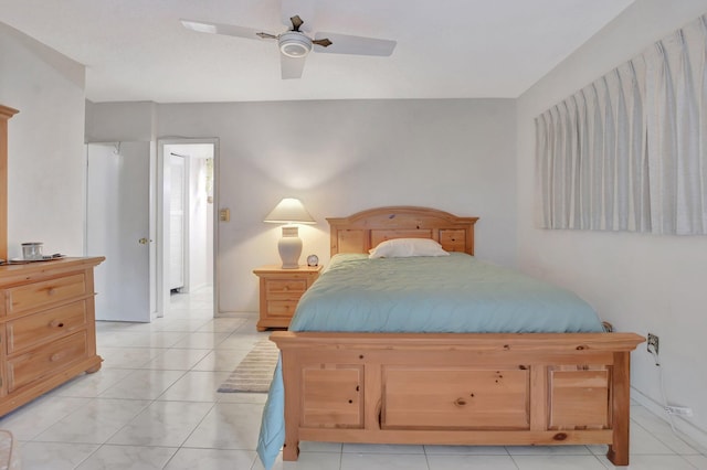 tiled bedroom featuring ceiling fan