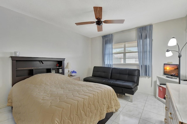 tiled bedroom with ceiling fan and a textured ceiling