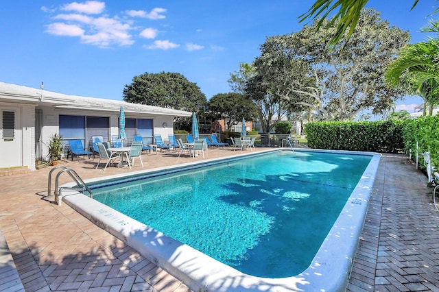 view of swimming pool with a patio