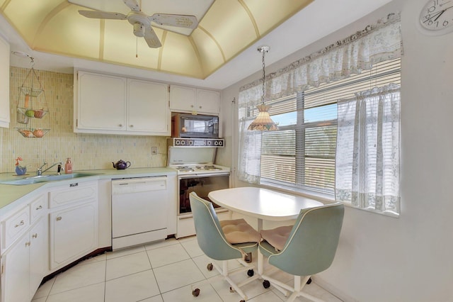 kitchen featuring pendant lighting, a healthy amount of sunlight, white appliances, and white cabinetry