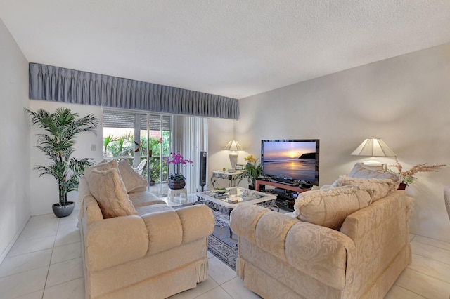 tiled living room featuring a textured ceiling