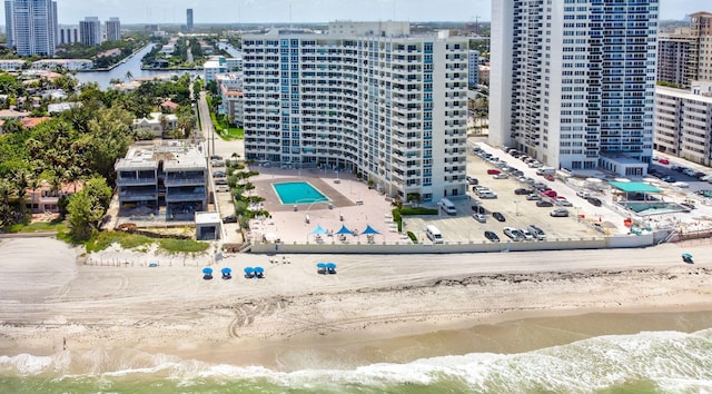 drone / aerial view with a beach view and a water view