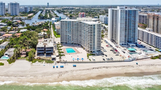 drone / aerial view featuring a beach view and a water view