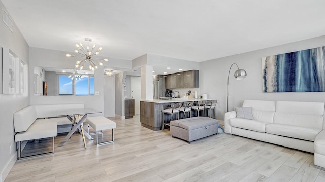 living room featuring light hardwood / wood-style flooring and a notable chandelier