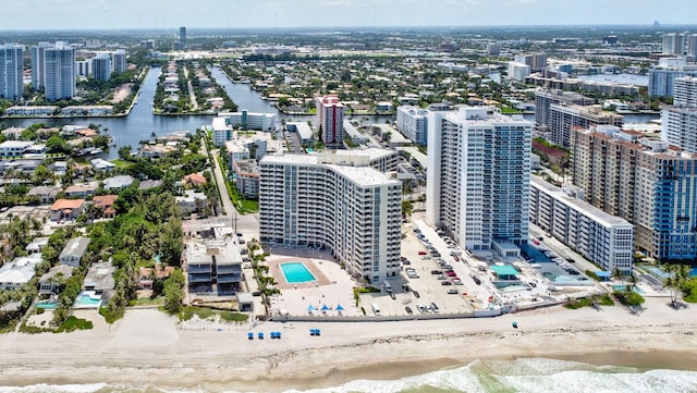 drone / aerial view with a water view and a view of the beach