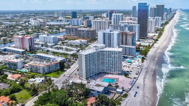 bird's eye view featuring a water view and a beach view