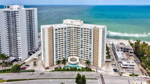 bird's eye view with a water view and a beach view