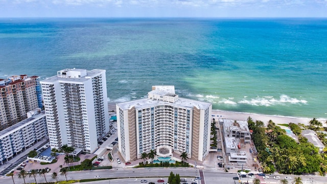 birds eye view of property featuring a view of the beach and a water view