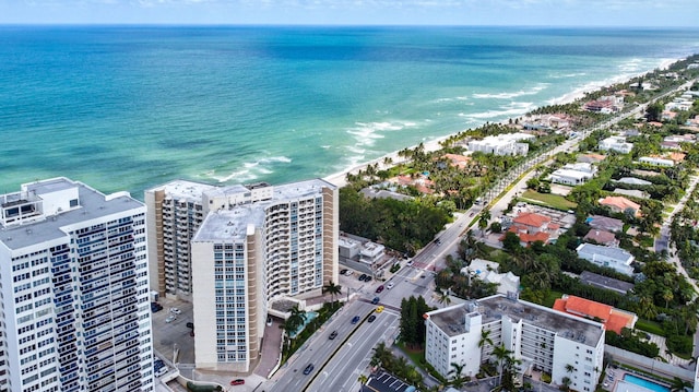 drone / aerial view with a water view and a view of the beach