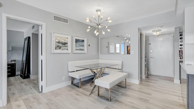 dining room featuring an inviting chandelier and light hardwood / wood-style flooring