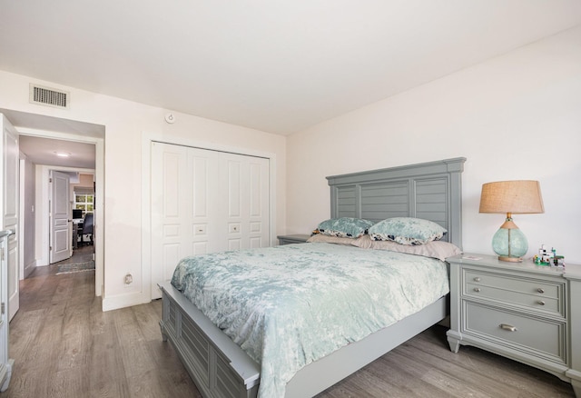 bedroom with light wood-type flooring and a closet