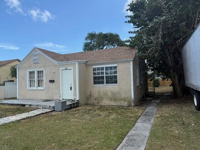 bungalow-style house featuring a front yard