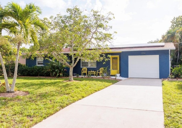 ranch-style house featuring a front lawn and a garage