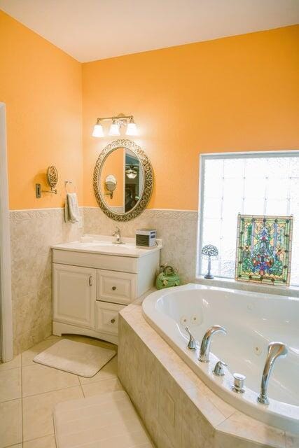 bathroom with vanity, tiled bath, and tile patterned floors