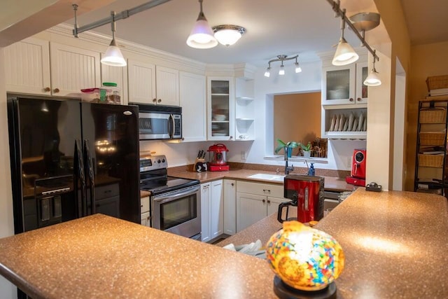 kitchen featuring appliances with stainless steel finishes, ornamental molding, sink, white cabinetry, and hanging light fixtures