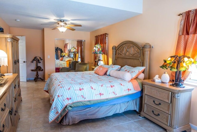 bedroom featuring dark tile patterned flooring and ceiling fan