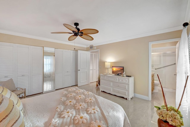 bedroom with multiple closets, ensuite bathroom, and crown molding