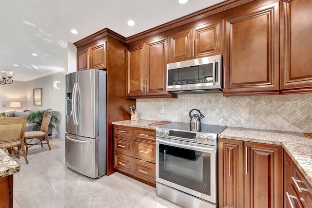 kitchen with decorative backsplash, light stone counters, stainless steel appliances, and crown molding