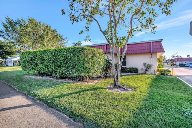 view of side of home featuring a yard