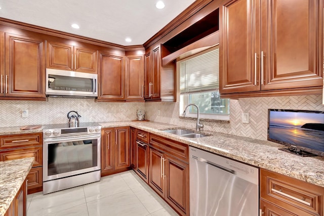 kitchen with light stone countertops, sink, stainless steel appliances, tasteful backsplash, and light tile patterned flooring