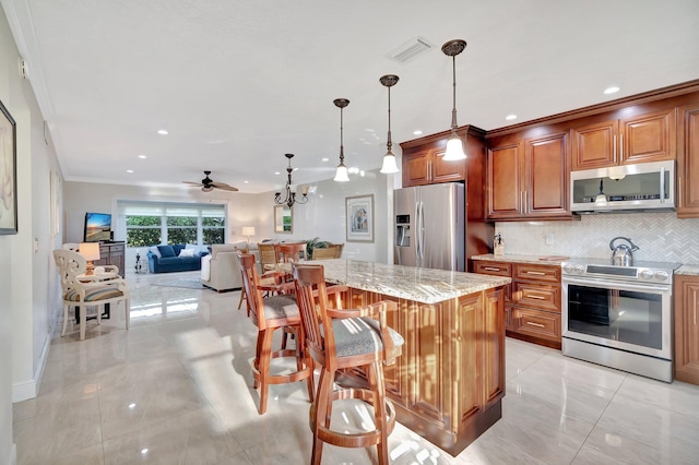 kitchen featuring a center island, tasteful backsplash, a kitchen breakfast bar, decorative light fixtures, and appliances with stainless steel finishes