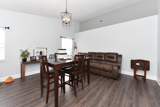 dining area featuring a chandelier, dark hardwood / wood-style floors, and a healthy amount of sunlight