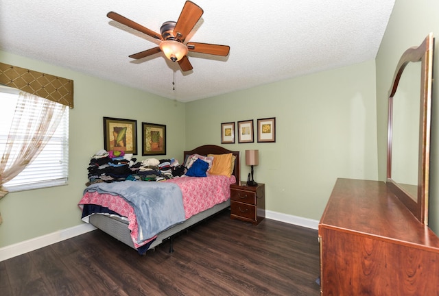 bedroom featuring a textured ceiling, ceiling fan, and dark hardwood / wood-style floors