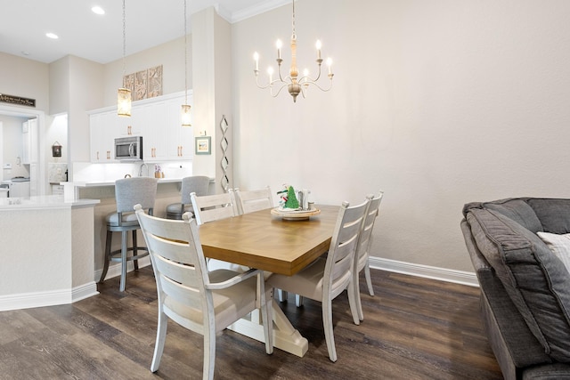 dining space featuring ornamental molding, dark wood-type flooring, and a notable chandelier