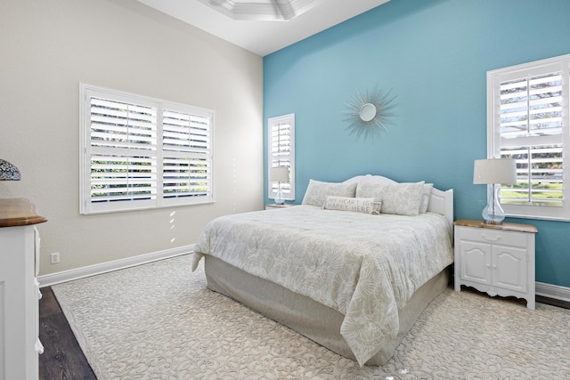 bedroom featuring multiple windows and wood-type flooring