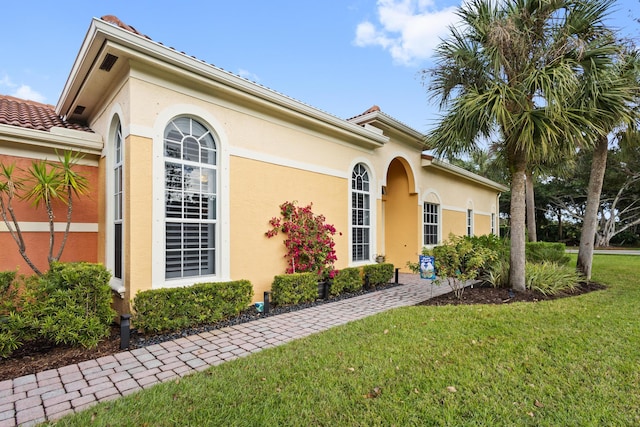 mediterranean / spanish-style house featuring a front yard