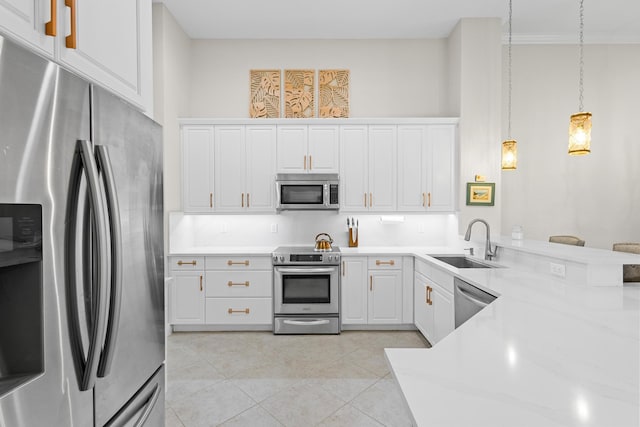 kitchen featuring sink, light tile patterned flooring, decorative light fixtures, white cabinets, and appliances with stainless steel finishes