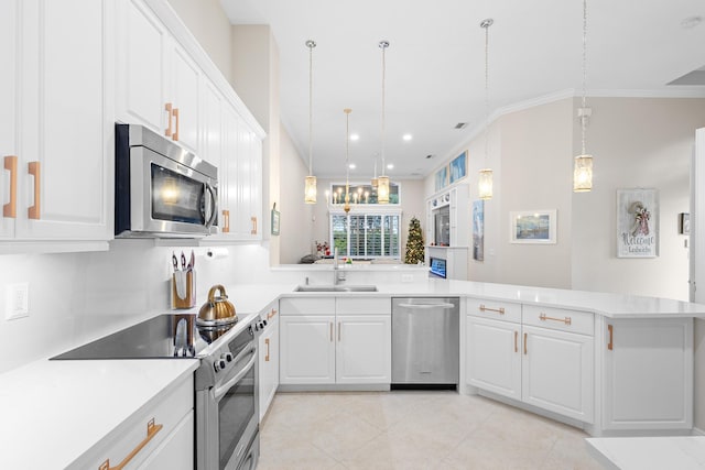 kitchen featuring kitchen peninsula, appliances with stainless steel finishes, crown molding, decorative light fixtures, and white cabinets