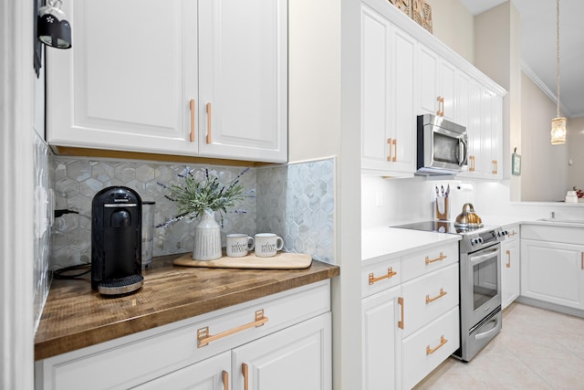 kitchen with white cabinetry, stainless steel appliances, hanging light fixtures, and tasteful backsplash